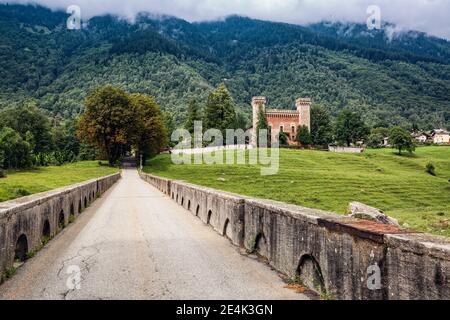 Switzerland, Canton of Grisons, Coltura, Old stone bridge with Castelmur Castle in background Stock Photo