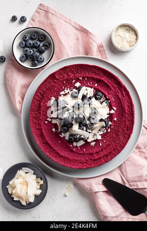 raw vegan cake with blueberries and coconut chips Stock Photo