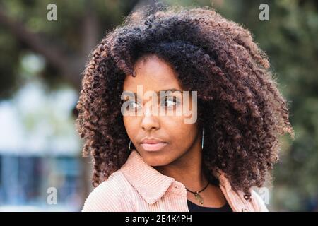 Confident young woman contemplating in city Stock Photo