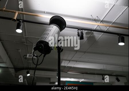 Studio light shining bounce lighting on ceiling in room Stock Photo