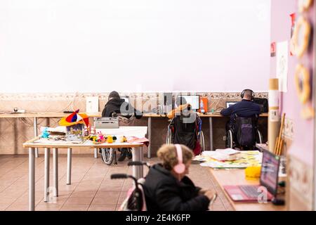 Disabled woman and man using laptop at rehabilitation center Stock Photo