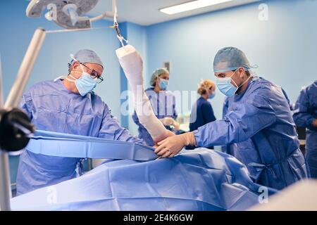 Doctors team working in operation room at hospital Stock Photo