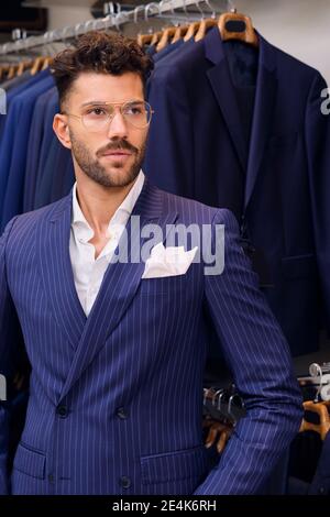 Portrait of man in blue pinstripe suit in tailors boutique Stock Photo