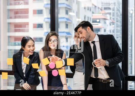 Multi ethnic business team brainstorming with discussing on board in modern office at business district Stock Photo