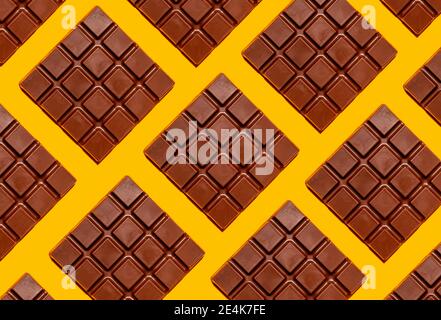 Pattern of chocolate bars against yellow background Stock Photo