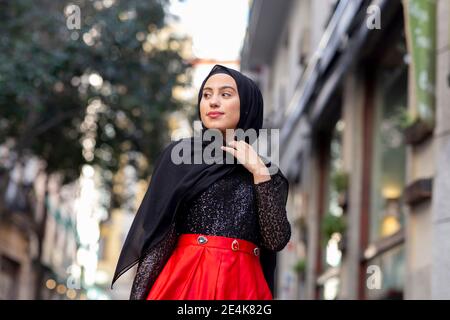 Portrait of young woman wearing black hijab standing outdoors Stock Photo