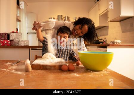 https://l450v.alamy.com/450v/2e4ka7t/cheerful-mother-screaming-while-mixing-ingredients-with-son-on-table-in-kitchen-2e4ka7t.jpg