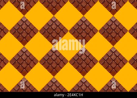 Pattern of chocolate bars against yellow background Stock Photo