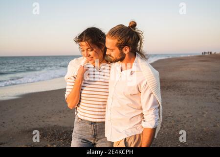 Romantic young couple walking at beach during vacation Stock Photo