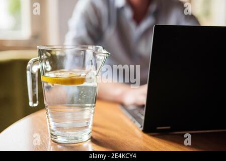 Male entrepreneur working over laptop on table at home Stock Photo