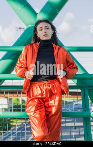 Confident young woman standing on bridge Stock Photo
