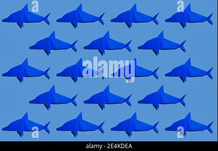 Blue dolphin's origami arranged on colored background Stock Photo