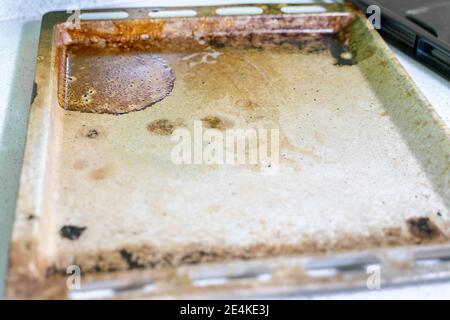 very dirty baking tray covered with grease and stains Stock Photo