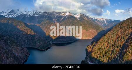Aerial view of Lake Ritsa surrounded by forested mountains in autumn Stock Photo