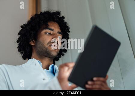 Confident male doctor using digital tablet at hospital Stock Photo