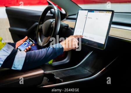 Mature male programmer using digital tablet in car Stock Photo