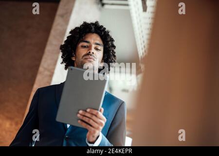 Confident businessman using digital tablet at workplace Stock Photo