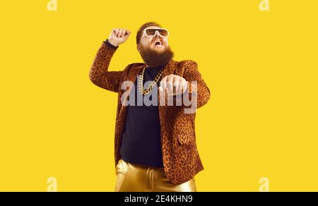Happy young man dancing gangnam style and having fun isolated on color background Stock Photo