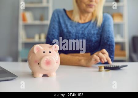 Mature woman with calculator planning her budget at home Stock Photo ...