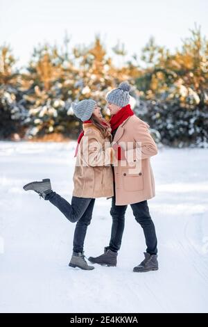 Romantic young couple bonding while walking on winter day Stock Photo