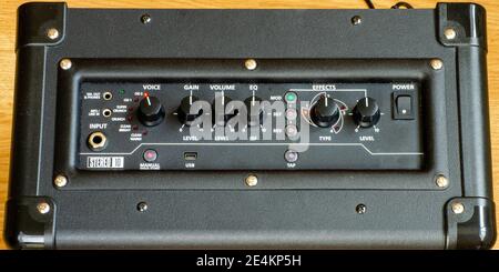 10 Watt electric guitar combo practice amp or amplifier black top view with LEDs lit and control knobs Stock Photo