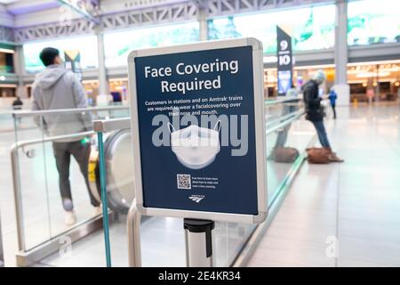 (210124) -- NEW YORK, Jan. 24, 2021 (Xinhua) -- A sign advertising a face mask requirement is displayed at the Moynihan Train Hall in New York, the United States, Jan. 23, 2021. The total number of confirmed COVID-19 cases in the United States topped 24.99 million, according to the data released by  Johns Hopkins University on Saturday. (Photo by Michael Nagle/Xinhua) Stock Photo