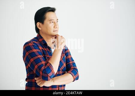 Pensive mature Vietnamese man Stock Photo