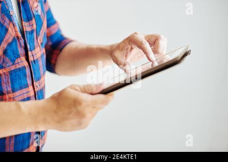 Man zooming image on tablet Stock Photo