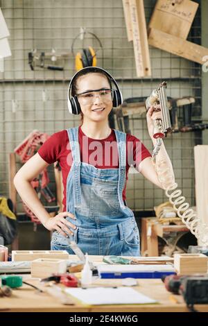 Young woman in carpentry workshop Stock Photo