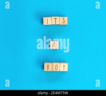 Its a Boy text written with wooden cubes with pastel blue background, Baby Shower or Nursery background Baby announcement. Flat lay,text space. top Stock Photo