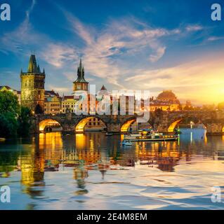 Fiery sunset over Charles bridge on river Vltava in Prague Stock Photo