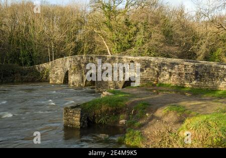 The old stone sheep dipping bridge over the River Ogmore near Marthyr Mawr in Bridgend County Borough Council.The bridge holes were to push the sheep Stock Photo