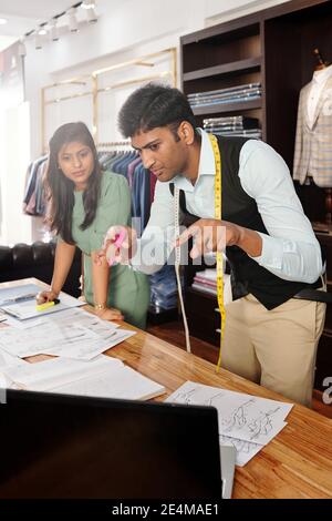 Young creative fashion designers working on new collection of menswear Stock Photo