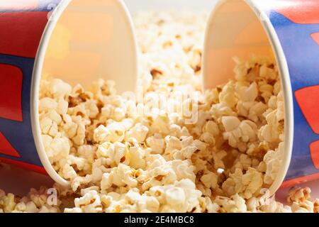 Popcorn scattered from two paper buckets. Concept of cinema. Stock Photo