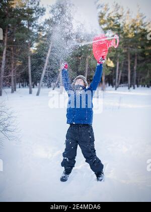 A little boy that is standing in the snow Stock Photo