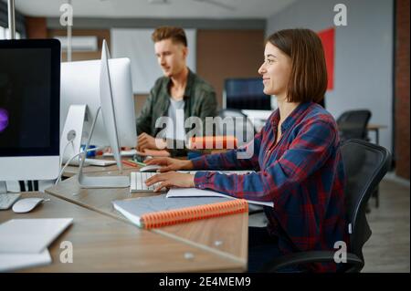 Two IT specialists works on computers in office Stock Photo