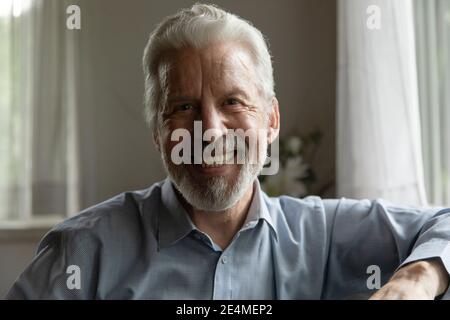 Head shot portrait smiling mature man looking at camera Stock Photo