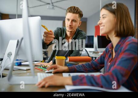 Two IT specialists works on computers in office Stock Photo