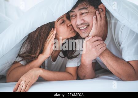 Happy Asian senior couple having good time at home. Old people retirement and healthy citizens elderly concept. Stock Photo