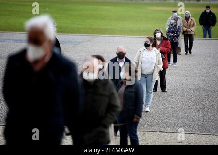 Lisbon, Portugal. 24th Jan, 2021. People wearing protective masks wait to cast votes at a polling station during the Portuguese Presidential Election in Lisbon, Portugal, on January 24, 2021. Portugal is voting despite the country's pandemic lockdown in a presidential election widely expected to see incumbent Marcelo Rebelo de Sousa win another term. Credit: Pedro Fiuza/ZUMA Wire/Alamy Live News Stock Photo