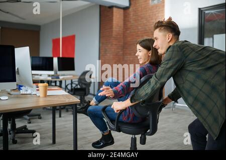 Cheerful IT specialists looks on monitor in office Stock Photo