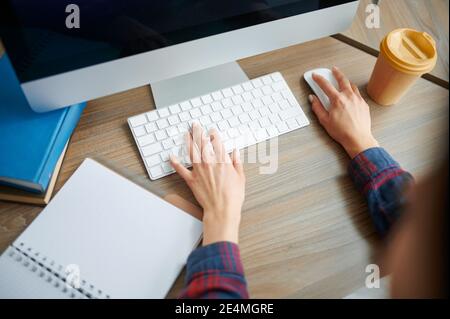 Female IT specialist hands on keyboard in office Stock Photo