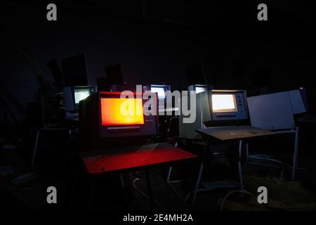 Old broken Soviet computers in abandoned computer hall. Stock Photo