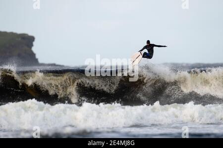 Hitting the Crest, Surfer in big wave Stock Photo