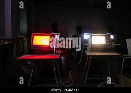 Old broken Soviet computers in abandoned computer hall. Stock Photo