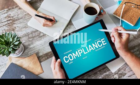 Compliance concept with icons and diagrams. Regulations, law, standards, requirements, audit. Concept on device screen