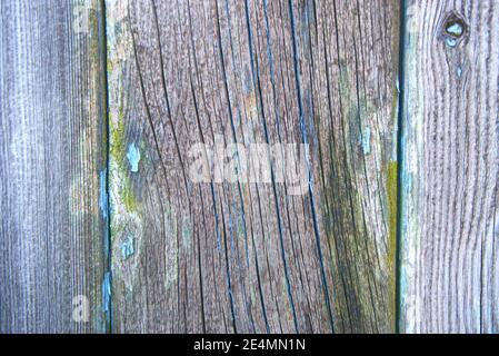 Close-up of an abstract pattern made by wood and the remains of peeling paint on an old garage door. Stock Photo