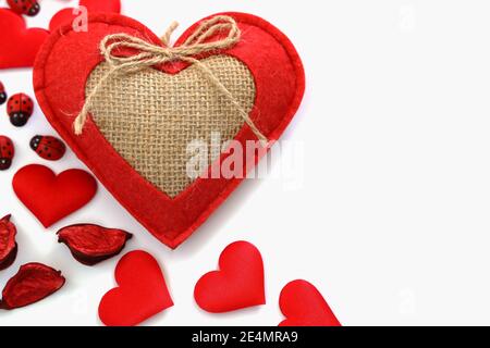 Top view composition, red hearts made of cotton decoration, valentine's day gift, love concept on top left corner of white background, Copy Space, Spa Stock Photo