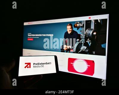Person holding mobile phone with logo of German mass media and broadcasting company ProSiebenSat.1 Media SE on display. Focus on smartphone screen. Stock Photo