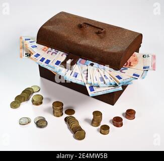 Old rusty cash box with Euro banknotes and coins Stock Photo